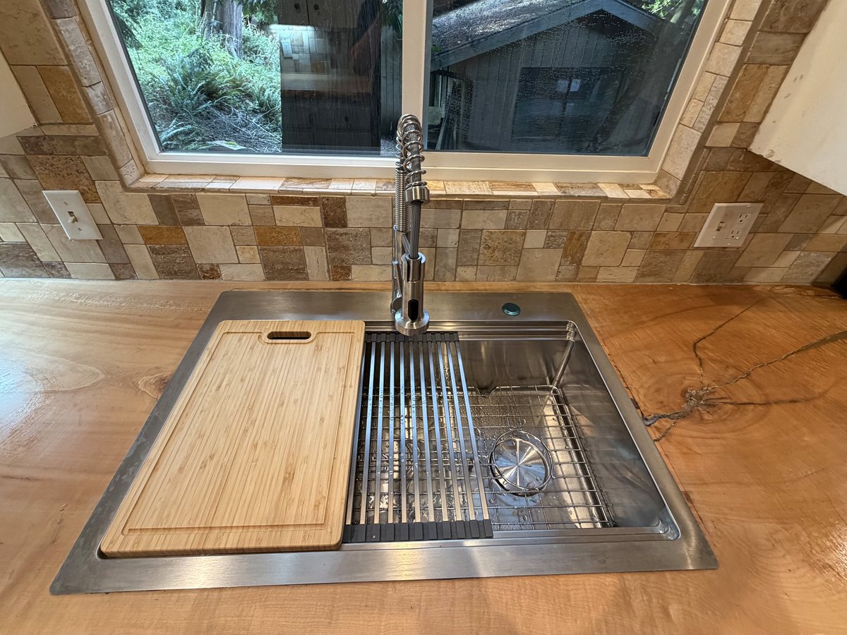 Wood countertop detail around a kitchen sink